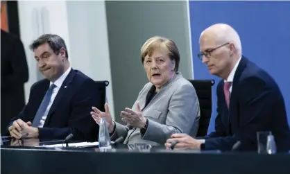  ?? Photograph: Bernd von Jutrczenka/AP ?? Angela Merkel, centre, with Bavaria’s premier, Markus Söder, left, and Peter Tschentsch­er, first mayor of Hamburg, at a press briefing on Wednesday.
