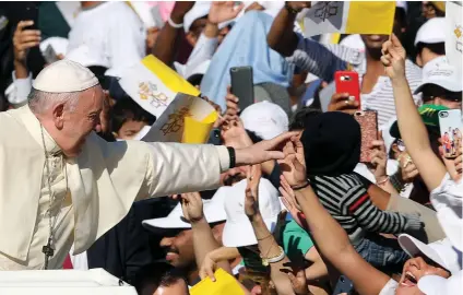  ?? (Photos: Reuters) ?? POPE FRANCIS waves to the enthusiast­ic crowd as he arrives to hold a mass at Zayed Sports City Stadium in Abu Dhabi, United Arab Emirates, on February 5.