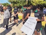  ?? ROD AYDELOTTE/ASSOCIATED PRESS ?? Members of the Baylor football team bow their heads in prayer during an on-campus march in Waco, Texas, staged in protest of the Jacob Blake shooting.