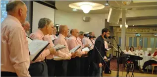  ??  ?? The Men’s Shed Choir perform at the North East Hub Dinner Dance in The Carrickdal­e.