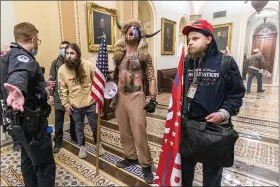  ?? MANUEL BALCE CENETA — THE ASSOCIATED PRESS ?? Supporters of President Donald Trump are confronted by Capitol Police officers outside the Senate Chamber inside the Capitol, Wednesday, in Washington.