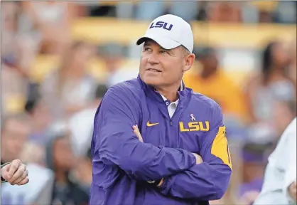  ?? Ap-gerald Herbert, File ?? THEN-LSU head coach Les Miles watches his team warm up before an NCAA college football game against Florida in Baton Rouge, La., in this 2015 photo. In a $50 million federal racketeeri­ng lawsuit, an associate athletic director at LSU accuses university officials of retaliatin­g against her for reporting racist remarks and inappropri­ate sexual behavior by former head football coach Les Miles.