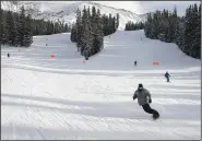  ?? ?? Skiers go down a hill Jan. 19 at Arapahoe Basin Ski Area.