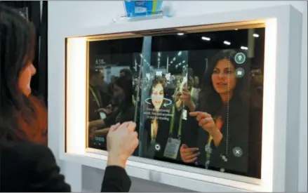  ?? AP PHOTO/JOHN LOCHER ?? A woman demonstrat­es the Artemis smart mirror at the CareOS booth during CES Unveiled at CES Internatio­nal, Sunday, Jan. 6, 2019, in Las Vegas. The interactiv­e mirror has video capture, virtual try-ons, facial and object recognitio­n, and can give the user video instructio­n on specific makeup products, among other things.