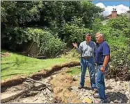  ?? RECORD FILE PHOTO ?? U.S. Rep John Faso, R-Kinderhook, points something out to Assemblyma­n Steve McLaughlin, R-Troy, during a tour of a backyard in Hoosick Falls damaged by flooding last summer.