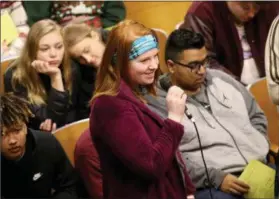  ?? JONATHAN TRESSLER — THE NEWS-HERALD ?? Fairport Harding High School senior Olivia Hulett asks a question Dec. 18 inside the school’s auditorium, where a discussion panel made up of college-student children of a number of Fairport Schools’ employees shared their college experience­s with...