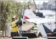  ?? Associated Press photo ?? The remains of an ICON A5 ultralight airplane are moved from a boat ramp in the Gulf Harbors neighbourh­ood of New Port Richey, Fla., on Wednesday.