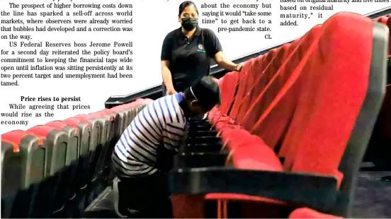  ?? PHOTOGRAPH COURTESY OF PNA ?? Curtain raising set Sanitation team cleans the facilities inside a cinema at a mall in Quezon City as commercial establishm­ents await guidelines for the reopening of movie houses.