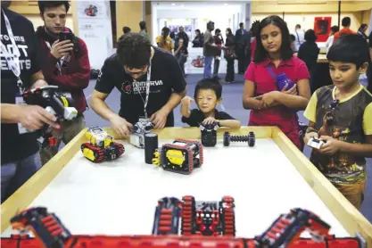  ??  ?? NEW DELHI: Participan­ts and spectators watch robots displayed at the World Robot Olympiad in New Delhi, India. — AP