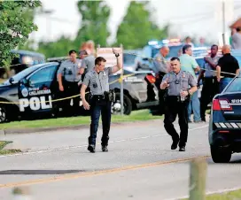  ??  ?? Police officers work the scene of a shooting that occurred on the east side of Lake Hefner at Louie’s Grill and Bar, 9401 Lake Hefner Parkway.