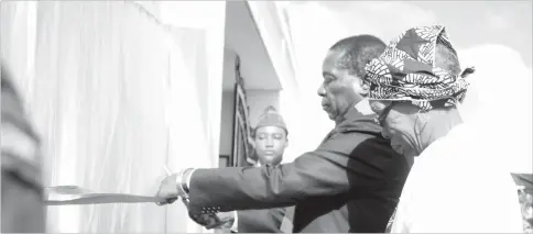  ??  ?? President Mnangagwa and late Zipra commander Alfred Nikita Mangena’s widow Sikubekiso Madeya Mangena cut the ribbon upon the naming of a cantonment area which houses Zimbabwe National Defence University to Rodgers Alfred Nikita Mangena barracks in...