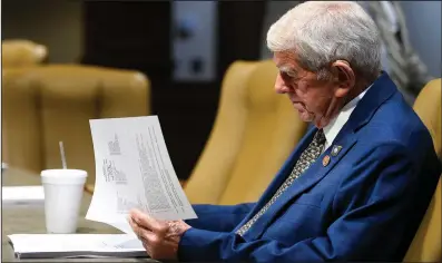  ?? (Arkansas Democrat-Gazette/Stephen Swofford) ?? State Rep. Dwight Tosh, R-Jonesboro, reads through the agenda as he waits for the start of a meeting of the Legislatur­e’s Joint Budget Committee near the state Capitol in Little Rock on Thursday.
