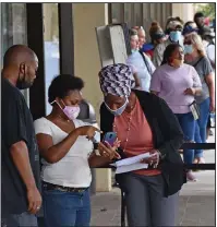  ?? (Arkansas Democrat-Gazette/Staci Vandagriff) ?? People wait in line to file unemployme­nt claims Thursday at the Arkansas Workforce Center in Little Rock.