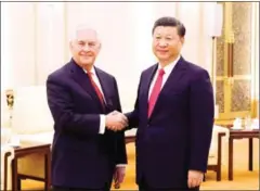 ?? THOMAS PETER/AFP ?? China’s President Xi Jinping (right) shakes hands with US Secretary of State Rex Tillerson in Beijing on March 19.