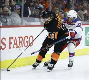  ?? MATT SLOCUM – THE ASSOCIATED PRESS ?? The Flyers Jake Voracek, left, on fire lately working with top-line mates Sean Couturier and Claude Giroux, fends off the Rangers’ Adam Fox Friday night at Wells Fargo Center. Voracek had four assists in a 5-2Flyers win.