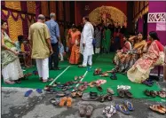  ?? ?? Devotees leave their sandals outside in reverence as they arrive to offer prayer to Hindu goddess Durga inside a makeshift worship place on the second day of Durga Puja festival.