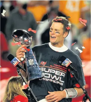  ??  ?? Tom Brady of the Tampa Bay Buccaneers hoists the Vince Lombardi Trophy after winning Super Bowl LV. See question 4