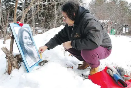  ?? PATRICK DOYLE/FILES ?? Bridget Tolley is a member of Families of Sisters in Spirit, which holds an annual vigil to draw attention to the cases of indigenous people who have died violently. Here, at a vigil in Gatineau Park in 2016, she places a photo of Kelly Morrisseau, who...