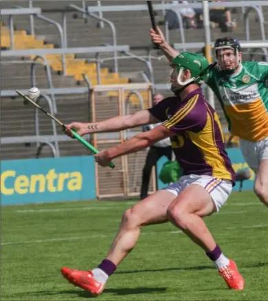  ??  ?? Conor McDonald about to selly a beautiful dummy to his namesake, Chris, the Offaly full-back whose father, Ciarán, and Offaly selector. The move ended in a second-half Wexford point.