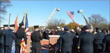  ?? SUBMITTED PHOTO ?? Local firefighte­rs and EMS personnel stand at honor in a tribute to their deceased fellow first responders at a special ceremony last Sunday at the Delaware County Fire and EMS Memorial in Rose Tree Park.