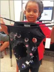  ?? EVAN BRANDT — DIGITAL FIRST MEDIA ?? Soraya Williams, 8, of Phoenixvil­le, shows off the Galaxy shirt she made during Friday’s program at the Pottstown Regional Public Library.
