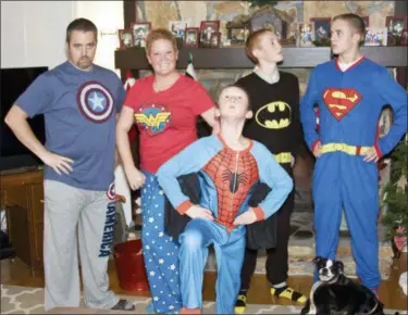  ?? AMY WILSON VIA AP ?? This Dec. 24, 2013 photo provided by Amy Wilson shows her children posing for a photo in matching holiday pajamas in her home in Marietta, Ga. For many families, dressing up in matching pajamas is a Christmas Eve and Christmas morning tradition — even when the kids get older.