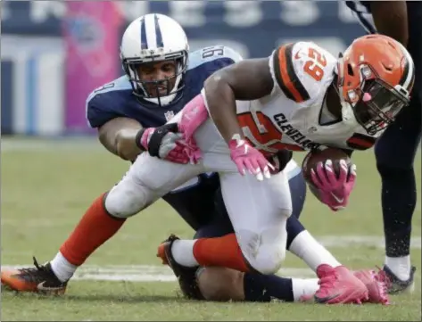  ?? ASSOCIATED PRESS FILE ?? Browns running back Duke Johnson is brought down by Titans defensive end Jurrell Casey in October in Nashville, Tenn. The Titans won, 28-26.