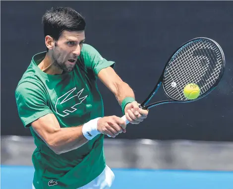  ??  ?? INTENSE COMPETITIO­N: Reigning champion Novak Djokovic, of Serbia, hits a return in practice ahead of the Australia Open.