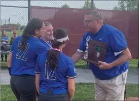  ?? JOHN KAMPF — THE NEWS-HERALD ?? Gilmour athletic director Sean O’Toole presents the Division III district runner-up trophy to members of the Lancers after a loss to South Range on May 19.