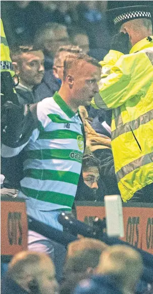  ??  ?? Stewards and police moved in after fans clashed with Leigh Griffiths.