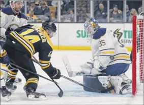  ?? Michael Dwyer / Associated Press ?? Buffalo goalie Linus Ullmark blocks a shot by Boston’s Chris Wagner during the second period Saturday. Wagner had one of Boston’s two goals in the Bruins’ victory. Ullmark made 39 saves in the losing cause.