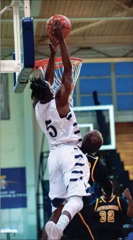  ??  ?? Georgia Northweste­rn’s Darrius Fugh skies above the rim to throw down an alley-oop slam during last week’s home game against Hiwassee. Fugh scored 39 points, a single-game record for the Bobcats, in a 78-67 win that moved the Bobcats back over .500 for...