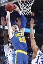  ?? WALLY SKALIJ/TRIBUNE NEWS SERVICE ?? UCLA's TJ Leaf scores (22) on Kentucky's Mychal Mulder, left, and Isaiah Briscoe (13) during UCLA's loss in Memphis, Tenn., on Friday. For the story, see Page 12.