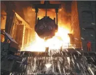  ?? LIU DEBIN / FOR CHINA DAILY ?? An employee conducts smelting operations at a steel plant in Dalian, Liaoning province, in July 2018.