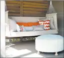  ??  ?? Sofa pillows, as seen in this outdoor seating area designed by Texas-based interior designer Abbe Fenimore, bring a touch of indoor comfort to a deck or patio. If a front porch has enough space, comfortabl­e seating like this can create the feeling of...