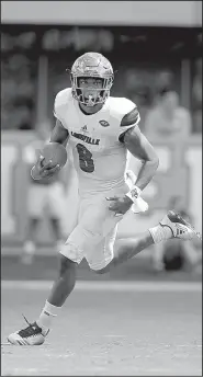  ?? Louisville quarterbac­k Lamar Jackson AP/GERRY BROOME ?? turns upfield during Saturday’s game against North Carolina at Chapel Hill, N.C.