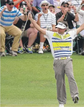  ??  ?? Bubba Watson basks in the moment of his birdie putt on the 14th. During his secondroun­d 68, the 2012 Masters champ birdied five in a row (12 through 16).