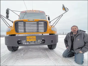  ?? Mark Thiessen
The Associated Press ?? Stretch Blackard, owner of Tok Transporta­tion, with an electric school bus Feb. 2 in Tok, Alaska. When the temperatur­e hits zero, his cost to run Tok’s electric bus doubles.