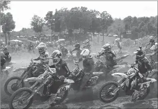  ?? STAFF PHOTO BY JOHN NISWANDER ?? Riders round a turn at the start of the 450 class title at the 2019 Lucas Oil Pro Motocross Championsh­ip at Budds Creek Motocross Park in Mechanicsv­ille. There will be no 2020 event this summer due to the coronaviru­s pandemic.