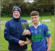  ??  ?? Bobby Dignam presents the cup to captain Daire Furlong.