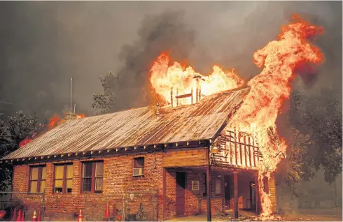  ?? AP ?? A historic schoolhous­e burns as the Carr Fire tears through Shasta, California, on Thursday.