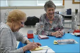  ?? SUSAN WALSH — THE ASSOCIATED PRESS ?? Barbara Steingaszn­er, 83, of Alexandria, Va., right, and Doris Askin, 84, of Mount Vernon, Va., left, play bridge at Hollin Hall Senior Center in Alexandria, Va., on Thursday.