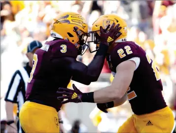  ?? ASSOCIATED PRESS ?? ARIZONA STATE RUNNING BACK ENO BENJAMIN (3) celebrates with teammate Nick Ralston after scoring a touchdown against UCLA during the first half of last Saturday’s game in Tempe.