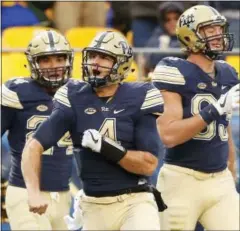  ?? JARED WICKERHAM — THE ASSOCIATED PRESS ?? Pittsburgh quarterbac­k Nathan Peterman (4) celebrates following his touchdown against Syracuse during the first half of an NCAA college football game in Pittsburgh, Saturday.