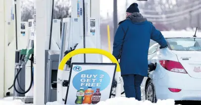  ?? AP ?? A customer pumps gas at a gas station in Wheeling, Ilinois on, January 19, 2024. On Friday, the University of Michigan released its preliminar­y reading of consumer sentiment for February.