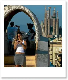  ?? GETTY IMAGES ?? People take photos in Barcelona, Spain, with La Sagrada Familia in the background.