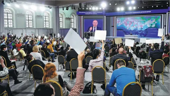  ?? NATALIA KOLESNIKOV­A / AFP ?? The questions come thick and fast for Vladimir Putin during the Russian president’s annual end-of-year news conference in Moscow on Dec 23.