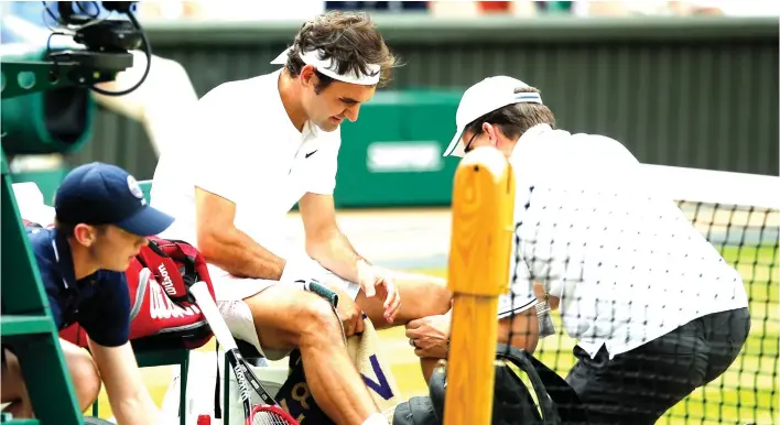  ?? (AP PHOTO/ALASTAIR GRANT, FILE) ?? IN THIS JULY 8, 2016, file photo, Roger Federer of Switzerlan­d receives medical attention during his men's semifinal singles match against Milos Raonic of Canada at the Wimbledon Tennis Championsh­ips in London. Federer says he will miss the Rio...