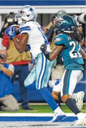 ?? AP PHOTO/ROGER STEINMAN ?? Dallas Cowboys wide receiver Amari Cooper makes a touchdown catch in front of Philadelph­ia Eagles cornerback Sidney Jones during the second half Sunday in Arlington, Texas. Cooper scored three touchdowns in the Cowboys’ 29-23 overtime victory.