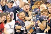  ?? By Dave Einsel, AP ?? Man of the people: Texans running back Arian Foster celebrates with fans after scoring a touchdown last weekend.